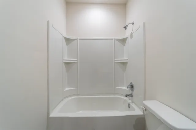 a bathroom with a bathtub and shower