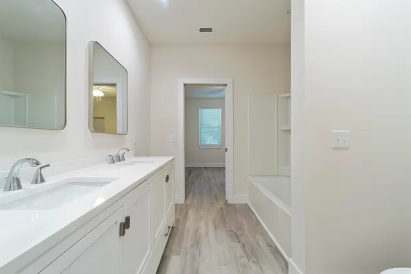 a bathroom with a sink a mirror and a bathtub