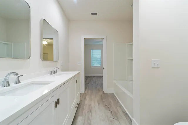 a bathroom with a sink a mirror and a bathtub