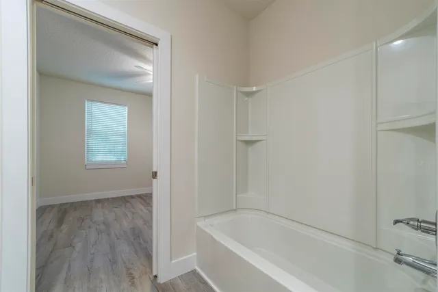 a white bath tub sitting in a bathroom