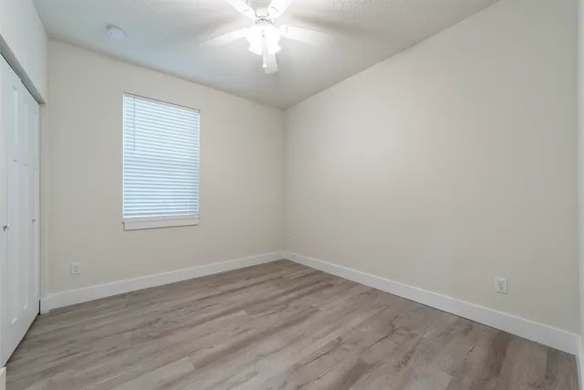 wooden floor in an empty room with a window