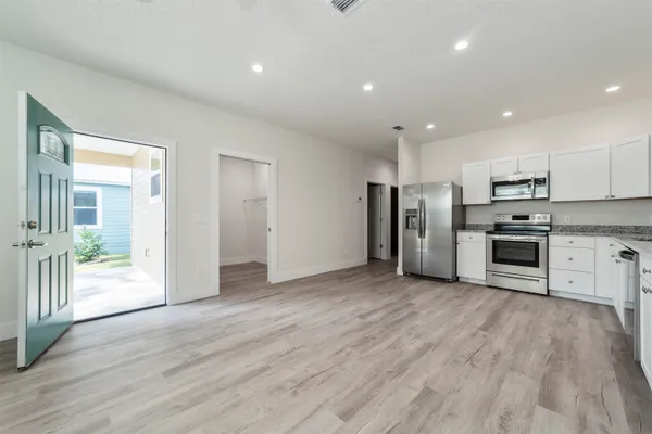 a view of kitchen with stainless steel appliances refrigerator oven and stove
