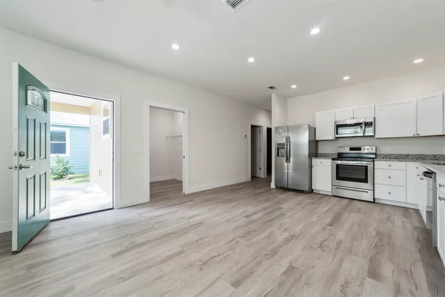 a view of kitchen with stainless steel appliances refrigerator oven and stove