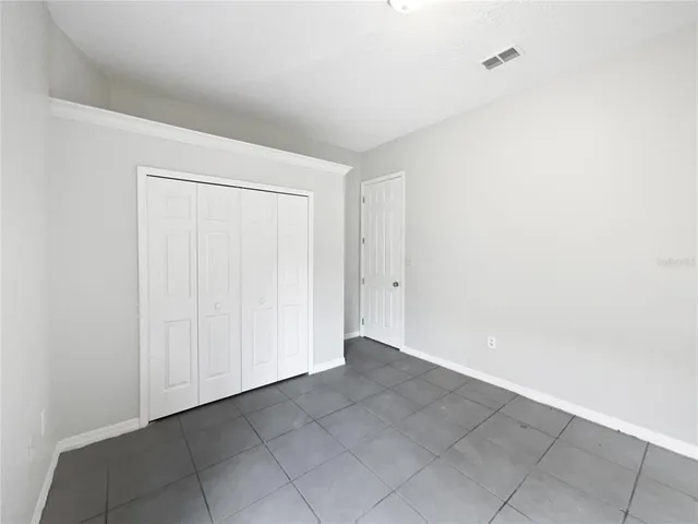 a bathroom with a granite countertop sink mirror and toilet