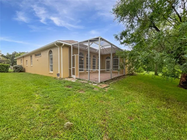 a front view of a house with yard and green space