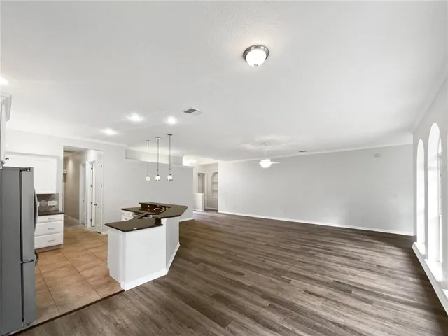 a view of a kitchen and refrigerator in a room