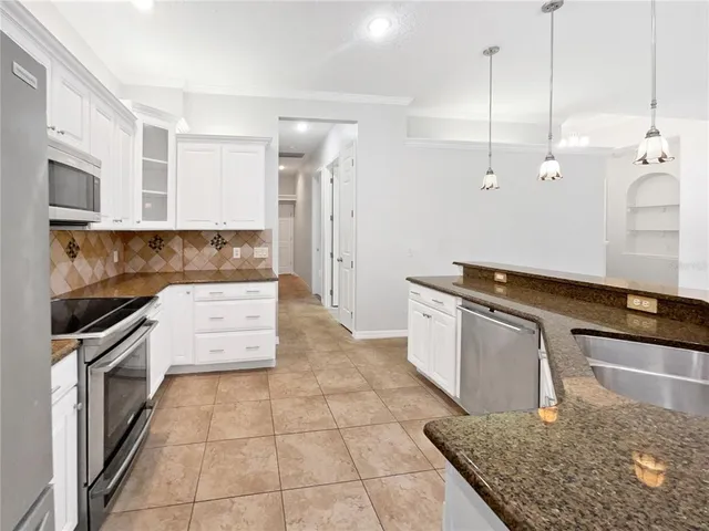 a kitchen with a stove a sink and a refrigerator