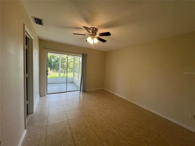 a view of a livingroom with a ceiling fan and window