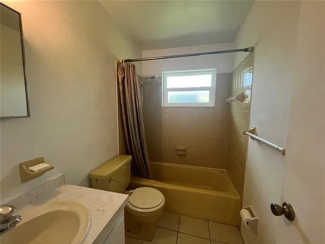 a view of hallway with furniture and a large window