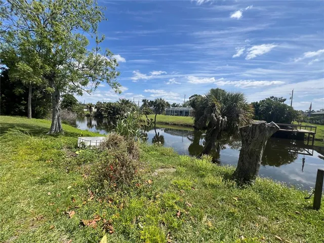 a house is sitting in middle of the green field