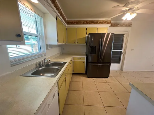 a kitchen with a sink a refrigerator and washer