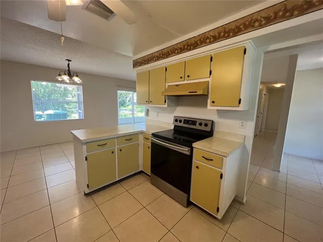 a kitchen with a sink and a stove top oven
