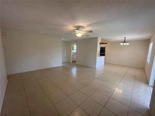 an empty room with a ceiling fan and a bathroom