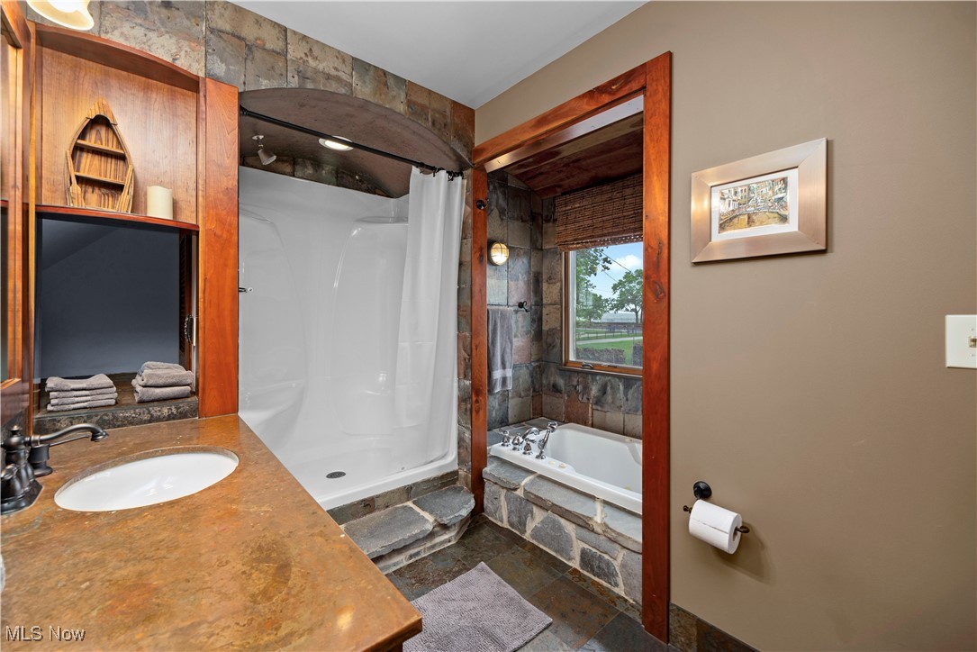 731 Cedar Point Road Sandusky, OH 44870 - Photo 30 of 50 The second floor full bathroom features a large jetted tub with serene lake views and a separate walk-in shower — a perfect blend of comfort and relaxation.