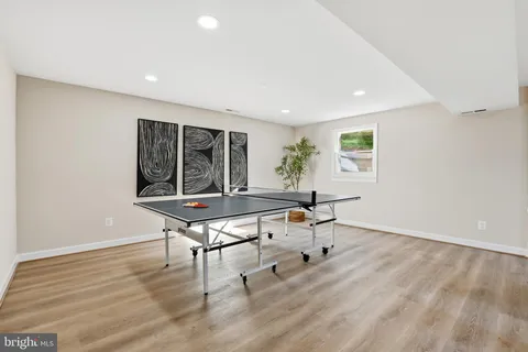 a room with furniture pool table and window