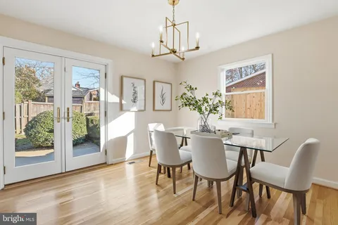a view of a dining room with furniture wooden floor and chandelier