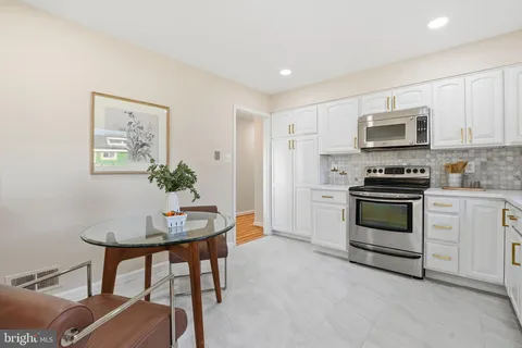 a kitchen with stainless steel appliances a stove a sink and a refrigerator