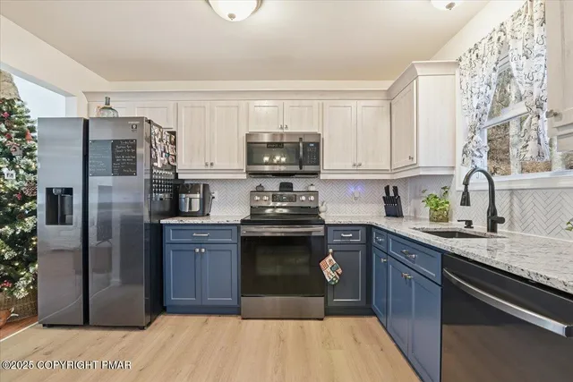 a kitchen with stainless steel appliances granite countertop a stove a sink dishwasher and a microwave