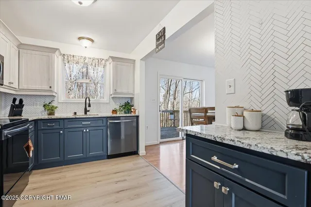 a view of a dining room with furniture wooden floor and chandelier