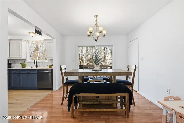 a kitchen with a table chairs stove and cabinets