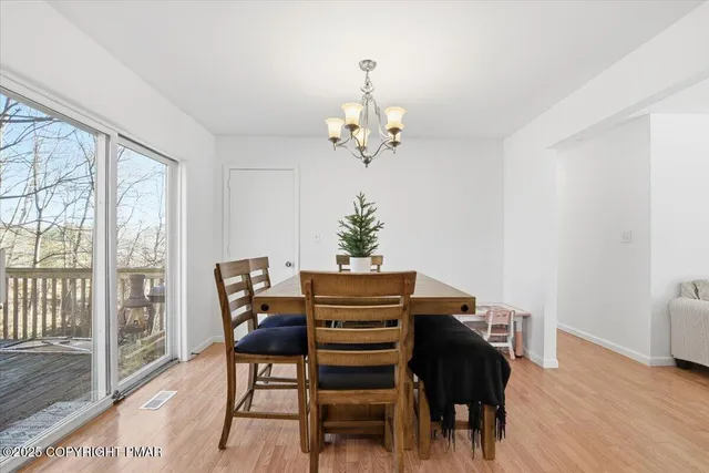a view of a dining room with furniture and chandelier