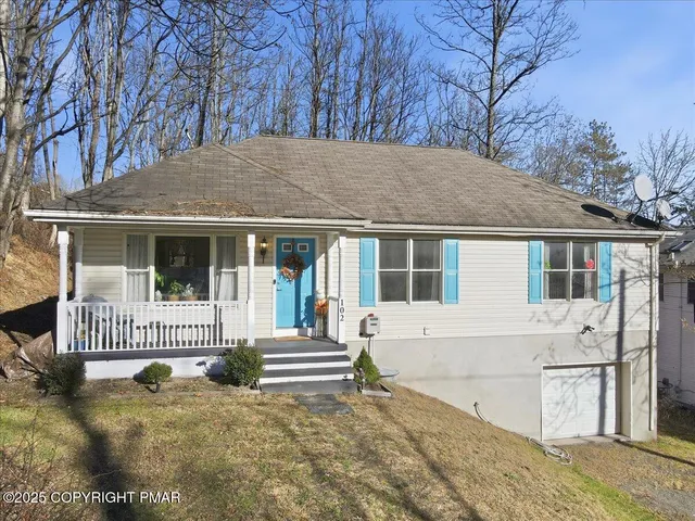 a front view of a house with a garden and yard
