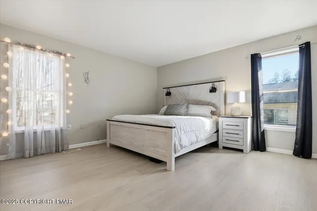 a bedroom with a bed and a dresser in it