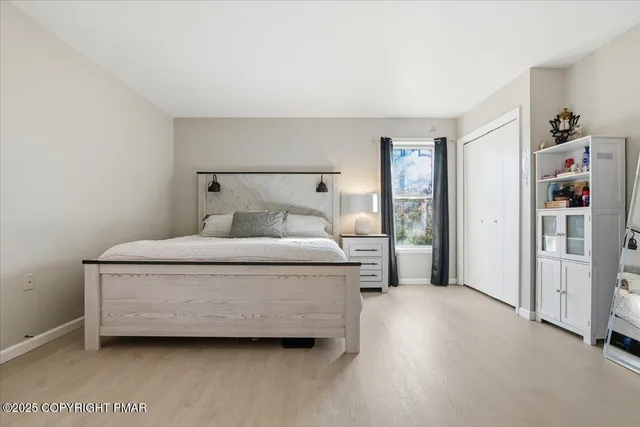 a bedroom with furniture and a flat screen tv