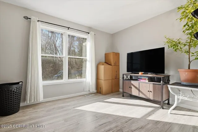 a bathroom with a granite countertop sink and a toilet