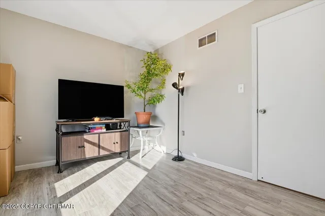 a bedroom with furniture and a flat screen tv