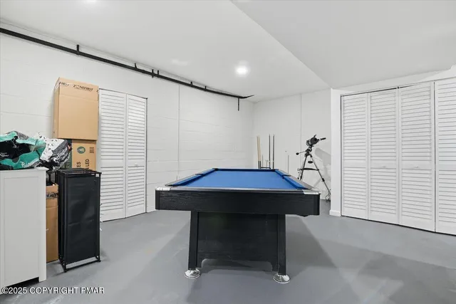 a view of a house with large trees and playing yard