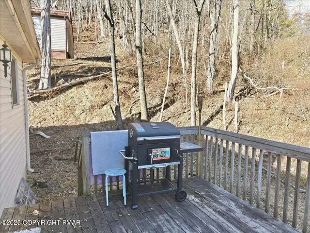 an aerial view of ocean and residential houses with outdoor space
