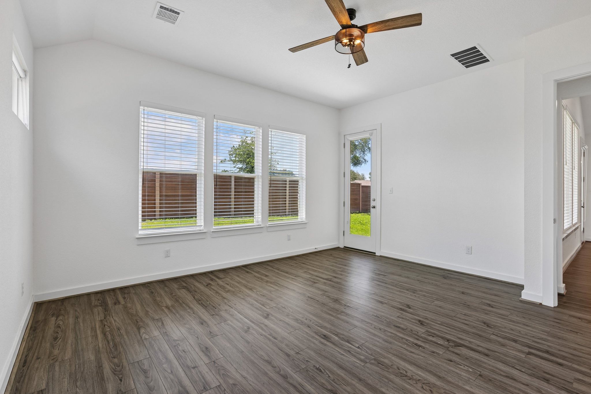 317 Independence Drive Kyle, TX 78640 - Photo 19 of 40 a view of an empty room with wooden floor and a window