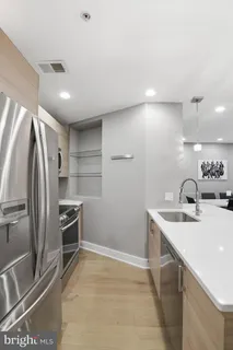 a kitchen with kitchen island a sink appliances and cabinets