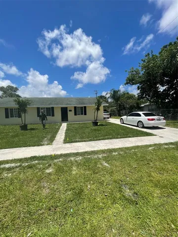 a view of house with outdoor space and sitting area