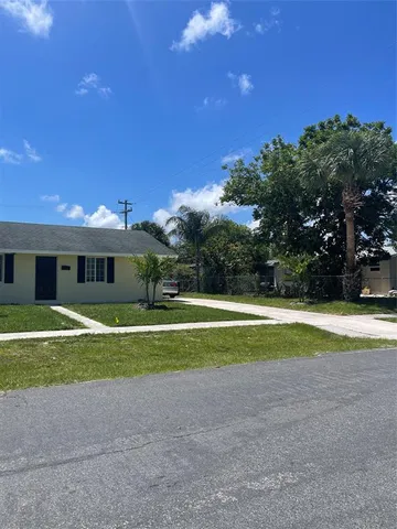 a view of a house with a yard and a garage