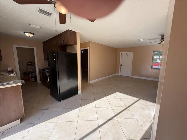 a view of a hallway to room with furniture