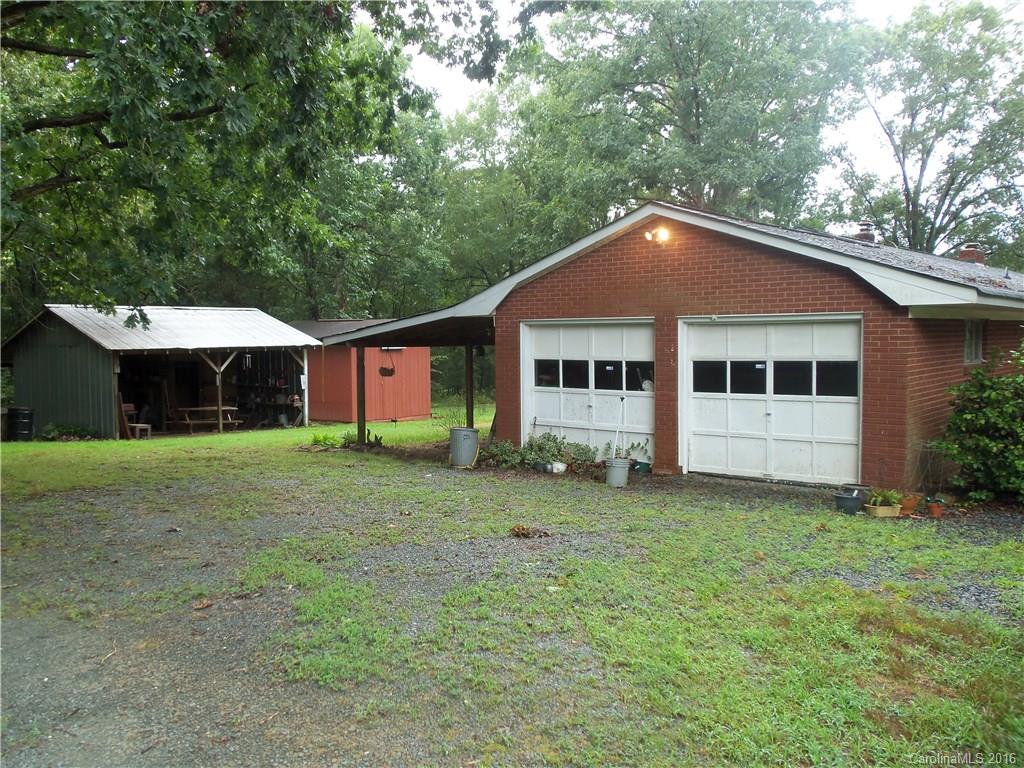 1216 Tom Helms Road Monroe, NC 28110 - Photo 22 of 23 a front view of a house with a garden