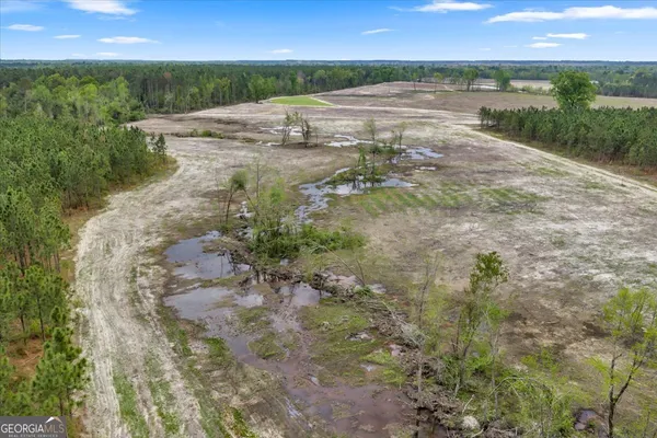 a view of a lake with beach and mountain view