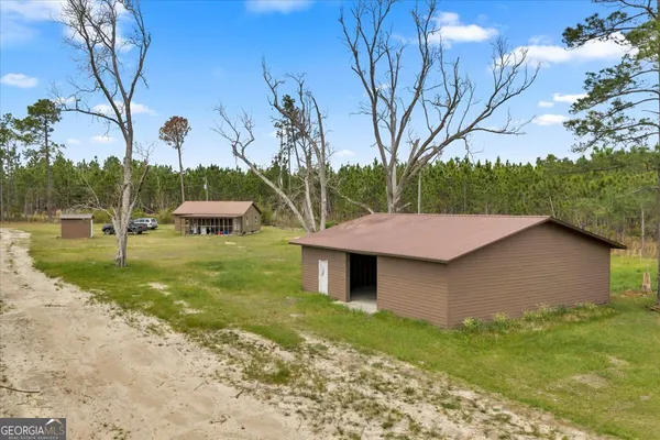 a view of a house with pool and a yard