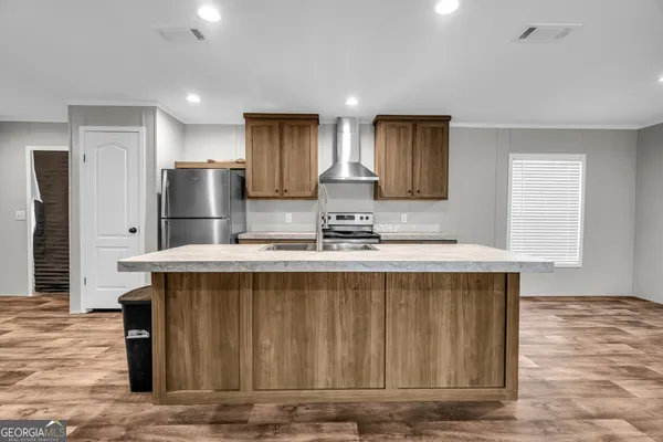 a view of kitchen with wooden floor