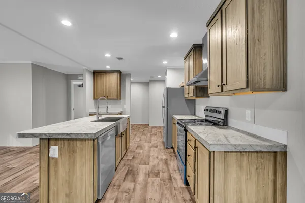 a kitchen with a sink and a refrigerator
