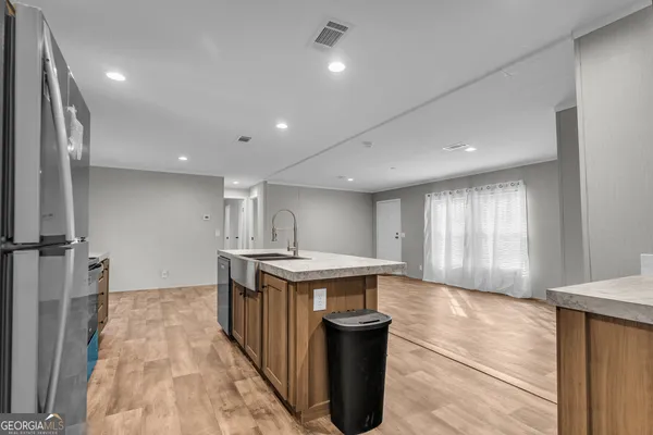 an empty room with a window and ceiling fan