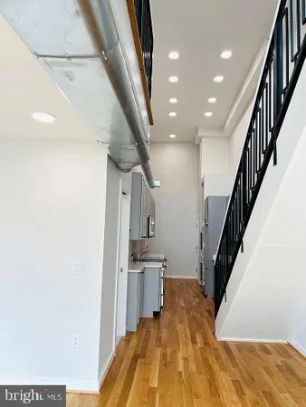 a view of a kitchen with furniture and stairs