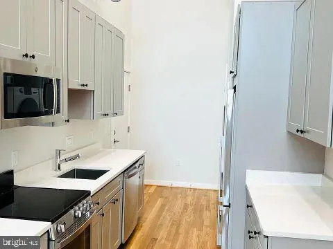 a kitchen with a sink cabinets and a stove