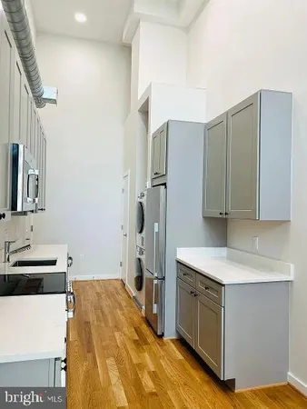 a kitchen with a sink stove and refrigerator