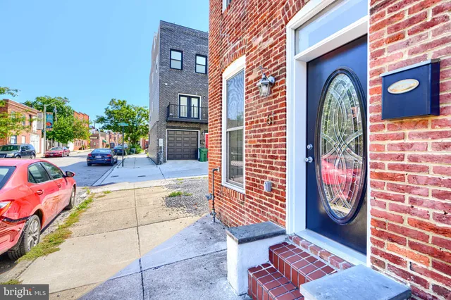a backyard of a house with barbeque oven table and chairs