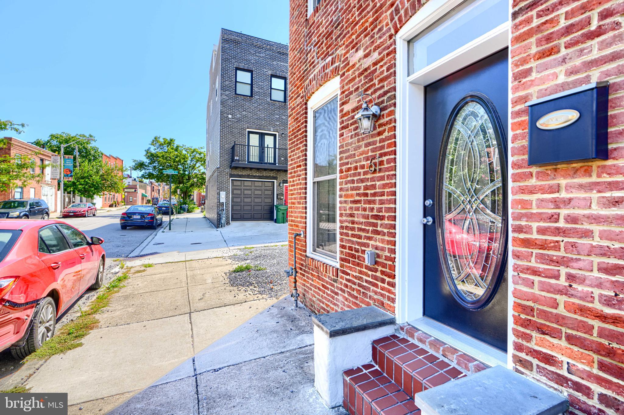 a backyard of a house with barbeque oven table and chairs