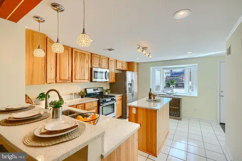 a kitchen with stainless steel appliances granite countertop a sink and a refrigerator