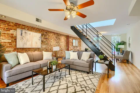 a living room with furniture and wooden floor